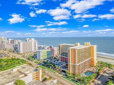 Birds eye view of property featuring a beach view 