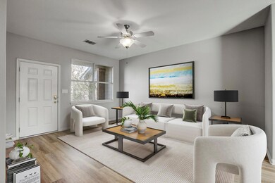 Living area featuring a ceiling fan and light woo