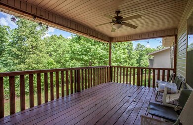 Large balcony with fan and serene views.
