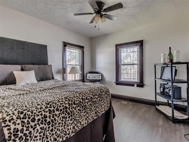 Master bedroom with hardwood floor and wood trim