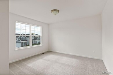 Empty room featuring light carpet