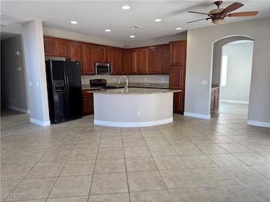 Kitchen featuring recessed lighting, arched walkwa