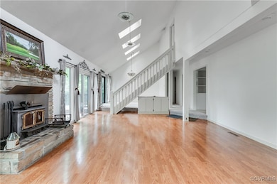 Unfurnished living room featuring stairs, a wood s