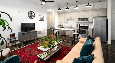 Living room with sink, dark hardwood / wood-style 