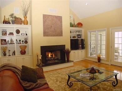 Vaulted ceiling greatroom has vented gas log firep
