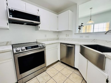 Kitchen with stainless steel appliances, white ca