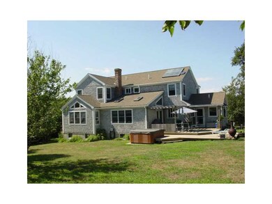 Exterior Back. New deck, hot tub.