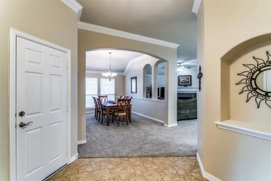 Carpeted dining area featuring ornamental molding 