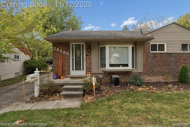 View of front facade with brick siding, a front lawn, roof with shingles, and a porch