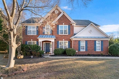 View of front of home featuring brick siding, a st