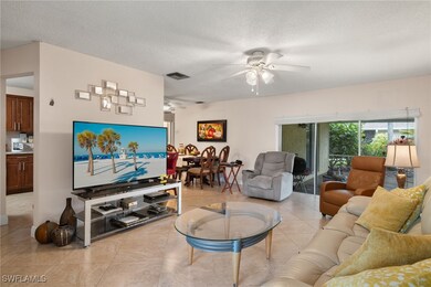 Tiled living room featuring a textured ceiling and