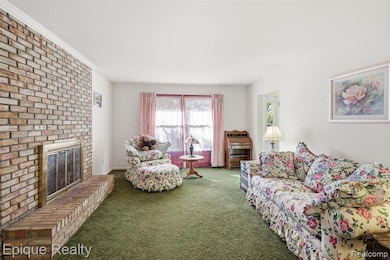 Living room with a fireplace and carpet floors