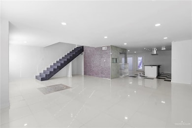 Unfurnished living room featuring tile walls and light tile patterned floors
