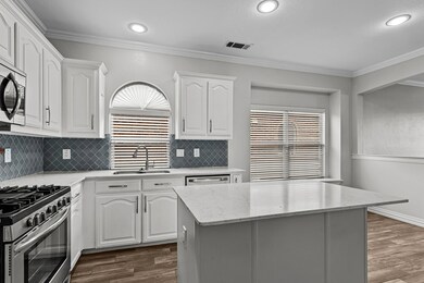 Kitchen featuring white cabinetry, dark wood-type 