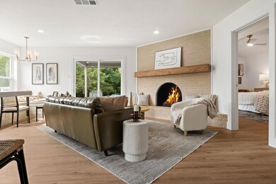 Living room with a fireplace, wood-type flooring, 