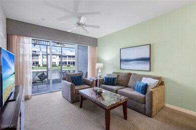 Living room with ceiling fan and light carpet