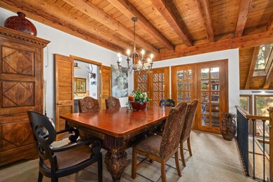 Dining room with wooden ceiling with exposed beams