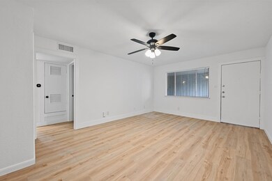 Unfurnished room with a ceiling fan, light wood-s