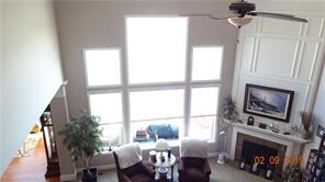 Great room with large windows , and deluxe fireplace