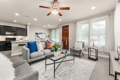 Living area featuring ceiling fan, recessed lighting, and light tile patterned floors