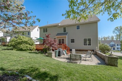Large Rear Deck off of the Family Room leads down to the lovely Paver Stone Patio, Sitting Walls, and Firepit for relaxing and grilling out this warm weather season!