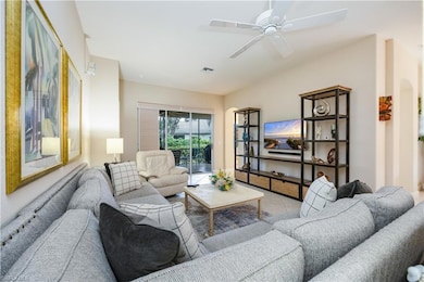 Tiled living area with ceiling fan and arched walkways