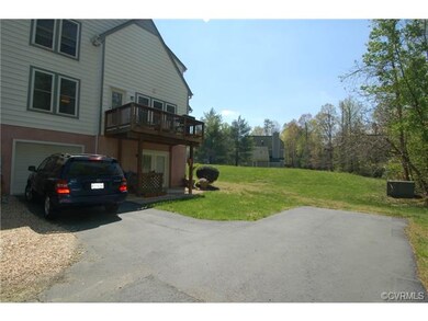 The deep one-car garage is accessed by a private n