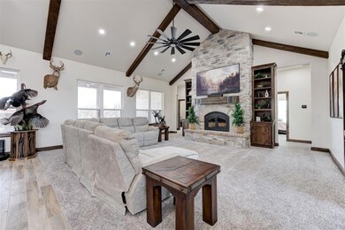 Living room featuring ceiling fan, high vaulted ce