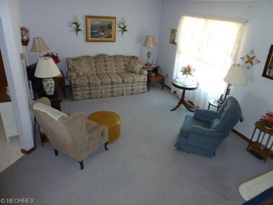 Living room, carpeting large window neutral decor