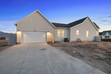 Single story home with concrete driveway, stucco siding, a garage, a shingled roof, and a gate