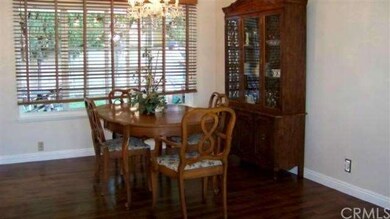 Formal dining room with chandelier, large window w