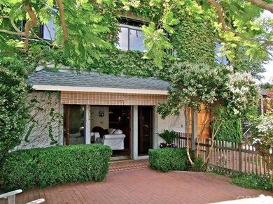 Large brick courtyard with French doors from livin