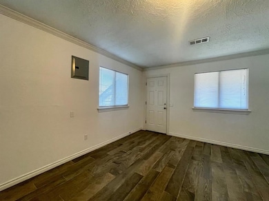 Unfurnished room featuring dark wood finished floo