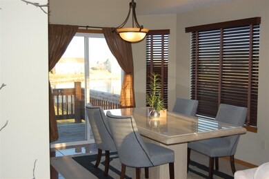 Spacious dining room with view to the pond.