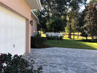 Extended Garage With Long Brick Pavers Driveway Wi