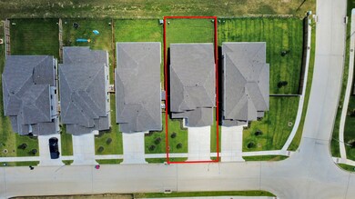 An aerial view of a spacious subdivision lot, highlighting a well-maintained yard and a fully fenced perimeter, offering both privacy and expansive outdoor space.