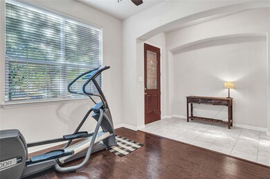 Workout area featuring light wood-type flooring an
