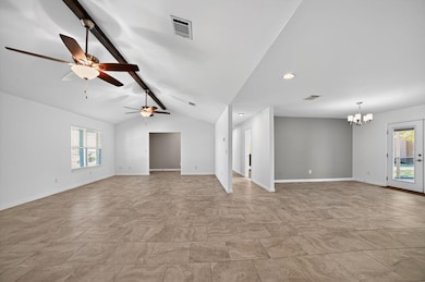 Spare room with a chandelier, a ceiling fan, and 