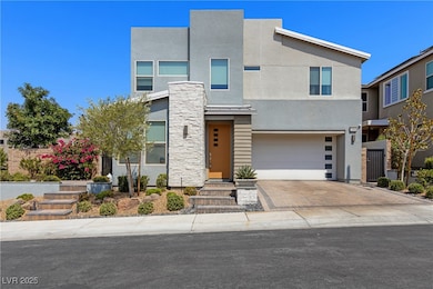 Contemporary house featuring driveway, stone sidin