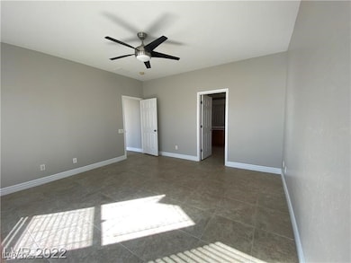 Unfurnished bedroom featuring baseboards, a walk i