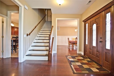 Beautiful wood door creates an inviting entrance.