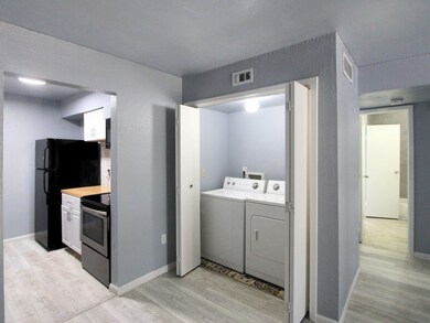 In-unit utility room with closable doors for privacy and convenience.