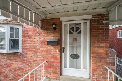 The welcoming covered front entry shields visiting
