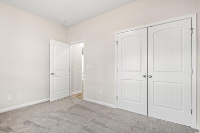 Unfurnished bedroom featuring carpet floors, baseb