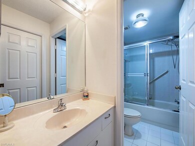 Bathroom with tile patterned flooring, toilet, van