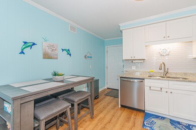 Kitchen featuring white cabinets, stainless steel 