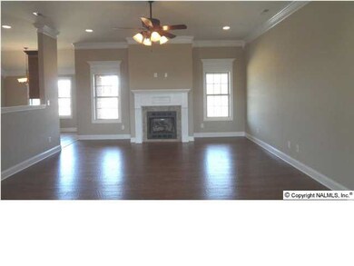 Family room, wood flooring, 10 ft ceiling, recessed lighting, fireplace.