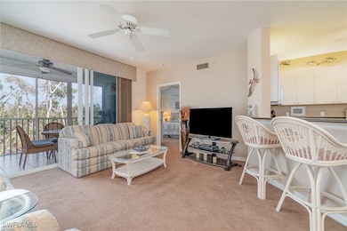 Carpeted living room with ceiling fan