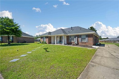 Single story home with brick siding and a front yard