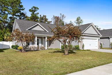 View of front of home with a porch, a garage, and 